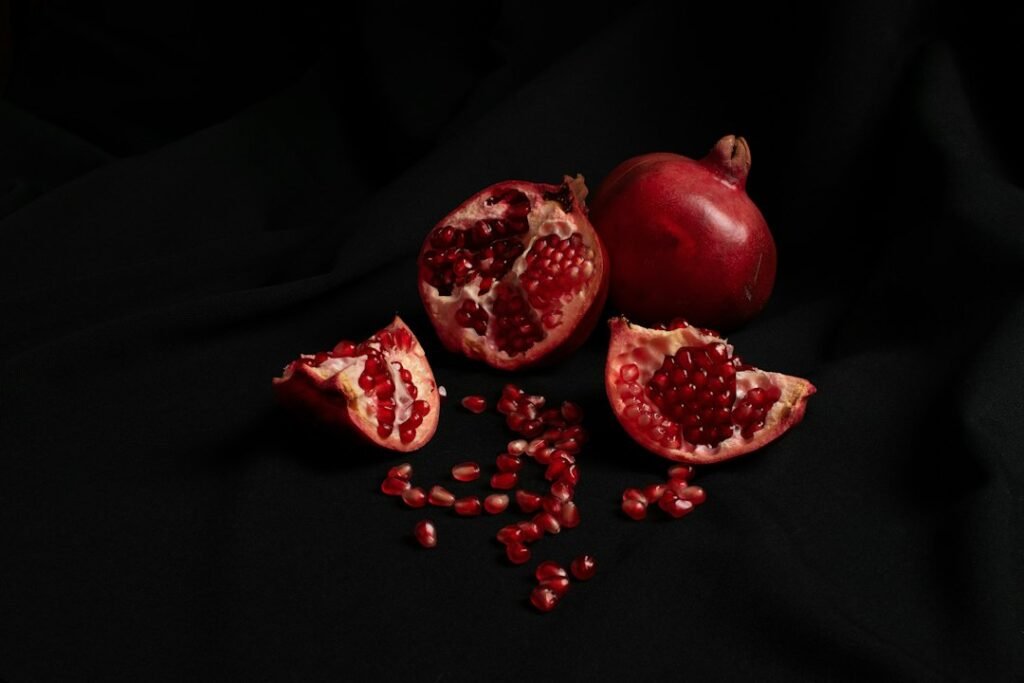 Open pomegranates against a dark background