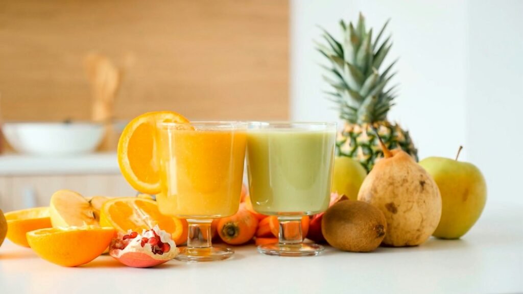 Orange juice and fresh fruit on a table