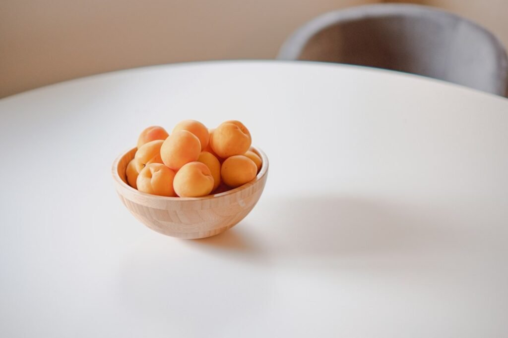 Fresh apricots in a ceramic bowl
