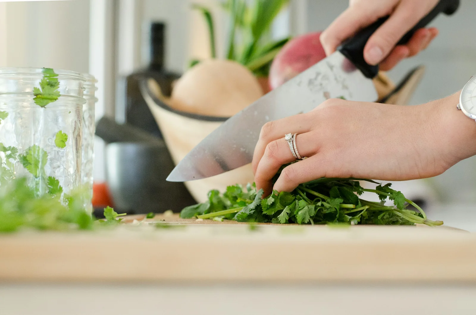 Hands preparing fresh herbs in a kitchen